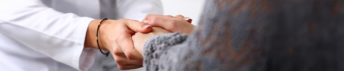 Doctor and patient holding hands